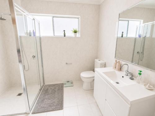 a bathroom with a shower and a toilet and a sink at Between the Blue Studio in Blacksmiths