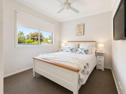 a white bedroom with a bed and a window at Between the Blue Studio in Blacksmiths