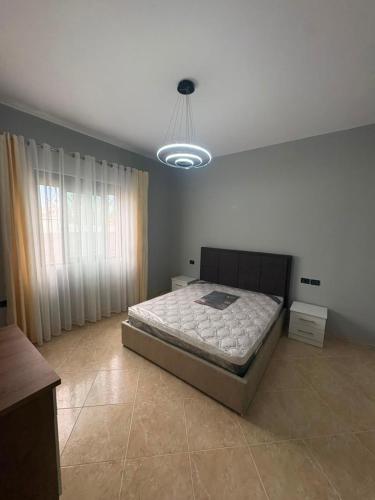 a bedroom with a large bed in a room at Casa bushi in Kamëz