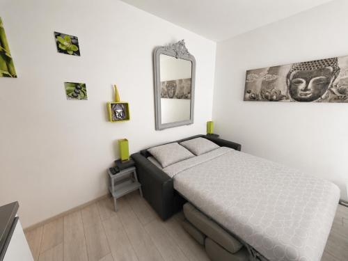 a bedroom with a bed and a mirror on the wall at Ancre Zen in Les Sables-d'Olonne