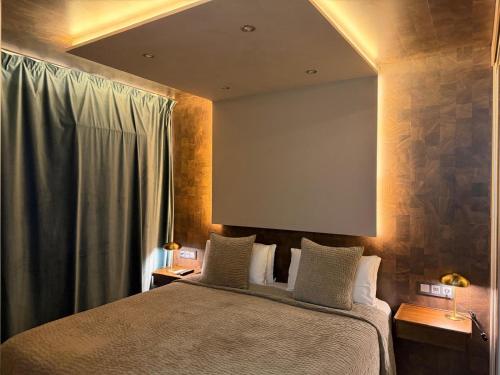 a bedroom with a bed with a mirror above it at Villa Adler Men Only in Playa del Ingles