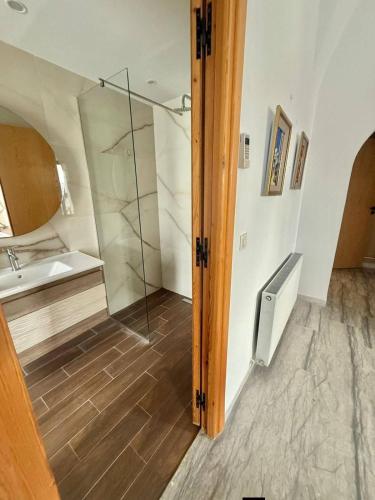 a bathroom with a shower and a sink at Villa Sky in Bin Rhilouf
