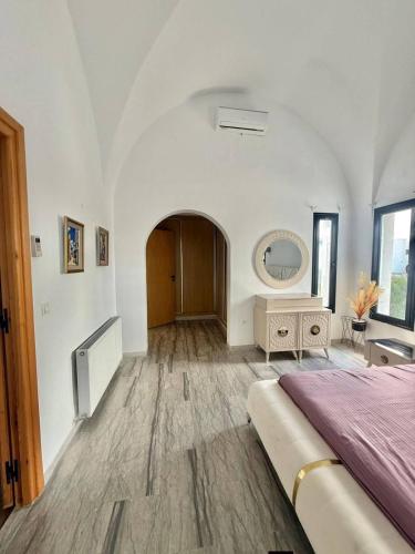 a bedroom with a bed and a mirror on the wall at Villa Sky in Bin Rhilouf