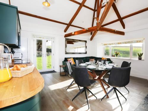 a kitchen and living room with a table and chairs at Shippon - Ukc9529 in Barnstaple