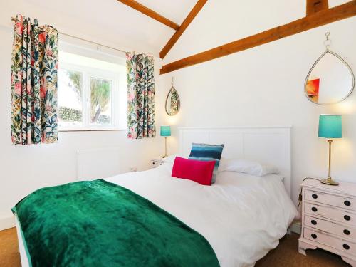 a bedroom with a large white bed and a window at Shippon - Ukc9529 in Barnstaple
