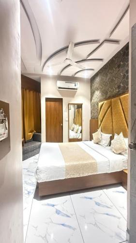 a bedroom with a large bed in a room with marble floors at Hotel Planet villa in Ahmedabad