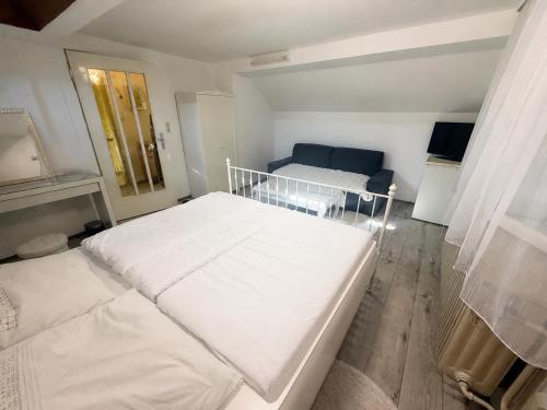 a bedroom with two white beds and a window at Private Top Floor Apartment near Sana Klinik in Offenbach