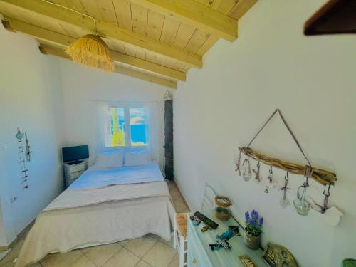 a bedroom with a bed and a table in a room at Myrto Signature Villa - Aegina in Aegina