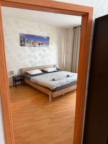a reflection of a bedroom with a bed in a mirror at KEY Accommodation Pellicova in Brno