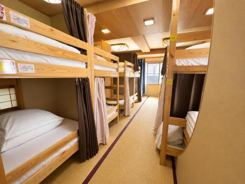 a group of bunk beds in a dorm room at Osaka Guesthouse Sakura in Osaka