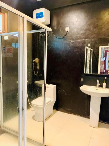 a bathroom with a toilet and a sink at City Hub Transit in Katunayaka