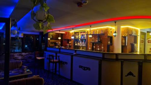 a bar in a restaurant at night with at Anadolu Hotel & Restaurant & Spa in Batumi