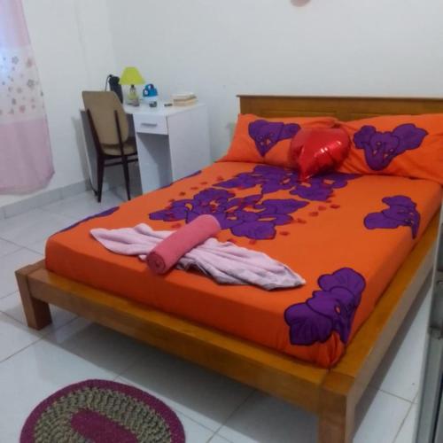 a large bed with clothes on it in a room at VILLA Moissuli maison entière confortable avec Starlink in Mtsamboro