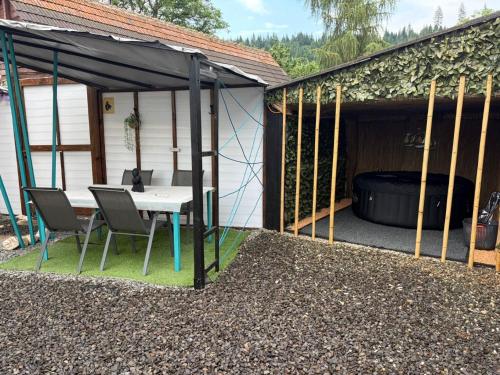 a patio with a table and chairs in a shed at Vila Zeus in Cristian