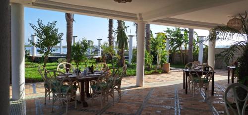 a patio with tables and chairs on a patio at Le Refuge in Larache