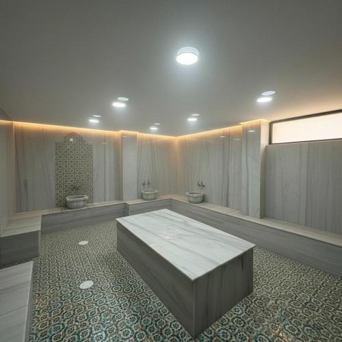 a room with two toilets and a bench in it at Bodrum Ada Suites Beach Hotel in Turgutreis