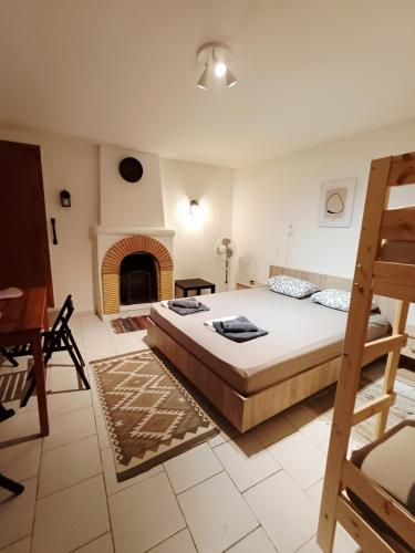 a bedroom with a large bed and a fireplace at Grandma's House Aliki Thassos in Alyki