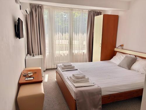 a bedroom with a large bed and a window at Vila Aqua in Eforie Sud