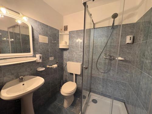 a bathroom with a shower and a toilet and a sink at Vila Aqua in Eforie Sud