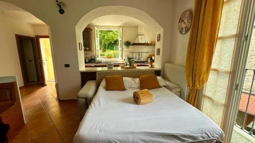 a bedroom with a large white bed in a room at La Ruota del Mulino in Nesso