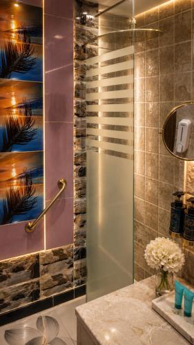 a shower with a glass door in a bathroom at هندباء Hindibaa in Mecca