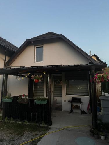 a house with an awning over a driveway at Apartman Dimitrijevic in Bajina Bašta