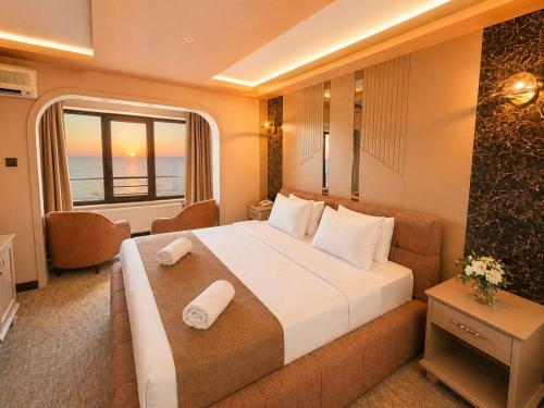 a hotel room with a large bed and a window at EMİRGAN Otel in Bağlık