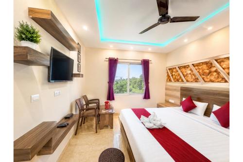 a hotel room with a bed and a tv at Hotel Sairaj inn - Restaurant - Free Wi-Fi - Premium Rooms - Balcony - Parking in Puri