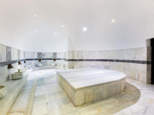 a large room with a large bed in the middle at Mercure Istanbul Bakirkoy in Istanbul