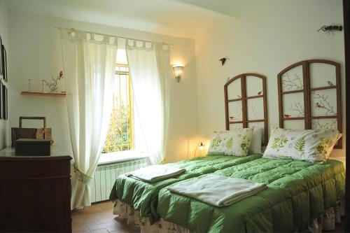 En eller flere senger på et rom på Le case della giardiniera