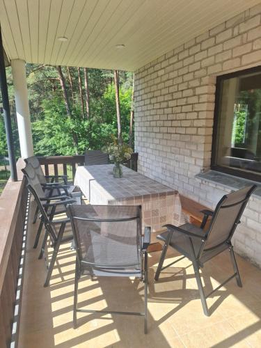 a group of chairs sitting on a patio at Pamiškės Villa in Kulautuva