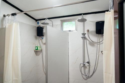 a bathroom with a shower with a shower curtain at Cloud Trails Hostel Ella in Ella