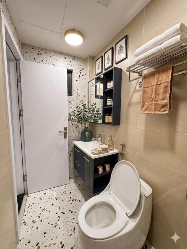 a bathroom with a toilet and a sink at Fuji Apartment in Hanoi