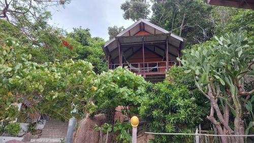 a tree house in the middle of a garden at Tao Thong Villa 1 in Ko Tao