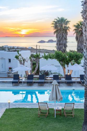 a pool with chairs and umbrellas at a hotel at Fragoulis Village in Parasporos