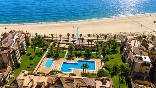 an aerial view of a resort with a beach at Alcaraván, Isla Canela - By AC REAL in Isla Canela
