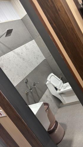 an overhead view of a bathroom with a toilet at Hotel Dhamija Divine inn Sirsa in Sirsa