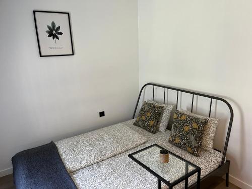 a couch with pillows and a table in a room at Near Ozas Studio in Vilnius