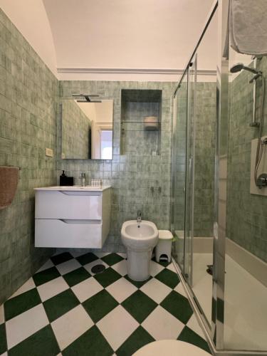 a bathroom with a toilet and a sink and a shower at Dietro la Piazzetta in Capri