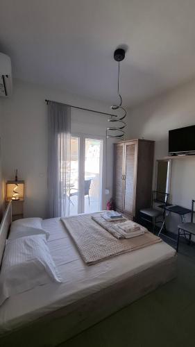 a large white bed in a bedroom with a window at The Suite in Kavála