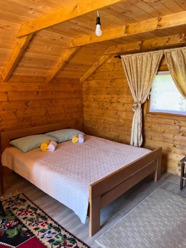 a bedroom with a bed in a log cabin at Wooden house in Šavnik