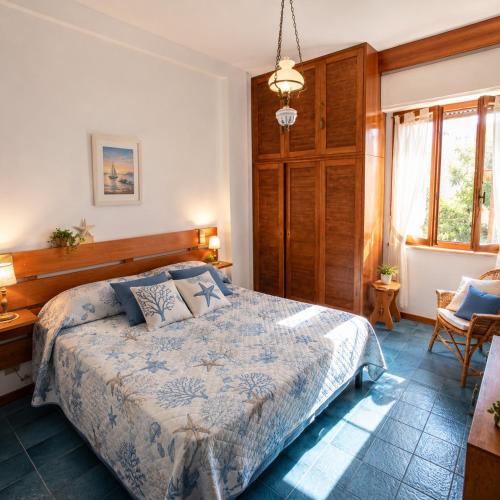 a bedroom with a large bed with a wooden headboard at Sea Horse in Lido di Camaiore