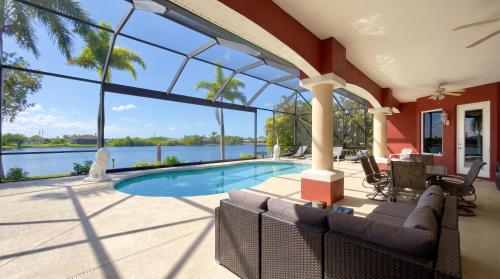 a house with a swimming pool and a large window at Villa Princess in Cape Coral