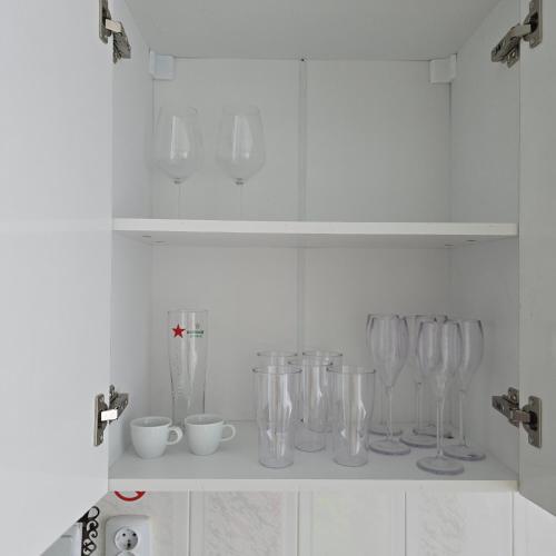a row of wine glasses sitting on a shelf at Happy House Garden in Plovdiv