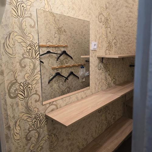 a bathroom with a large mirror and a sink at Happy House Garden in Plovdiv