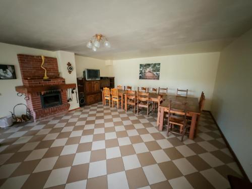 a living room with a table and chairs and a fireplace at Ezernieki in Valka