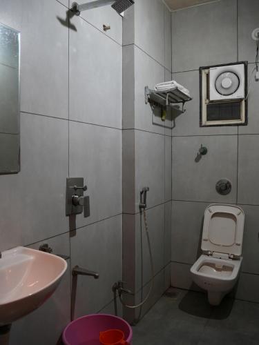 a small bathroom with a sink and a toilet at Hotel Trimurti Executive in Dāpuri