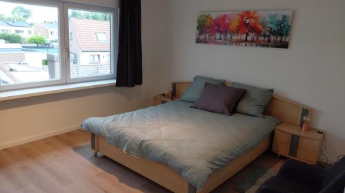 a bed in a room with a window at B-SIDE Loppem in Zedelgem