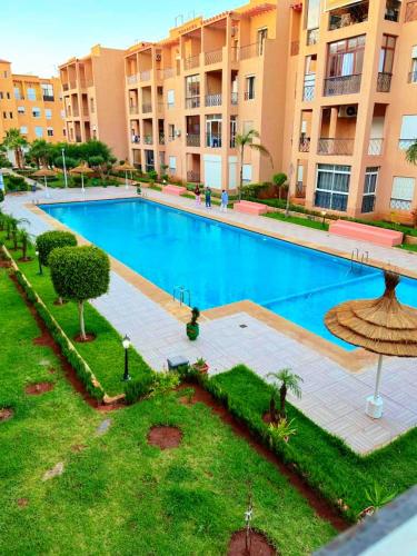 an overhead view of a large swimming pool in a building at Reco flores PALM in Ben Slimane