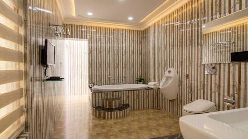 a bathroom with a tub and a sink and a toilet at MSG Hotels And Resort in Sirsa